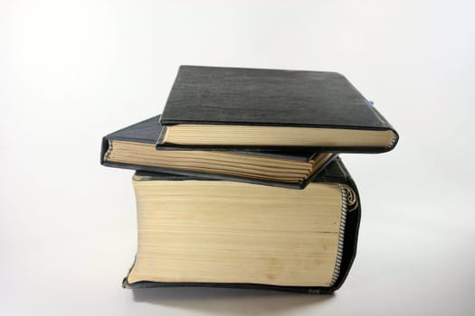 three old books closeup in white background prespective