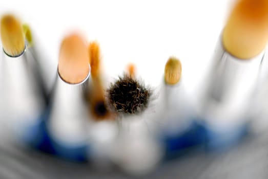 Macro of paintbrushes on white background top view