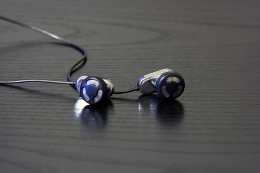 small head phones close up in black background