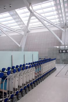 Luggage carts inside modern international airport