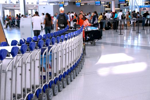 Passengers lining up at the check-in counter at the modern international airport