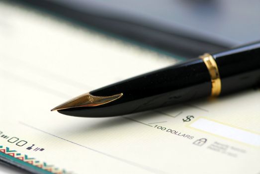 Gold fountain pen and cheque