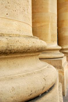 Closeup of row of stone columns in perspective 