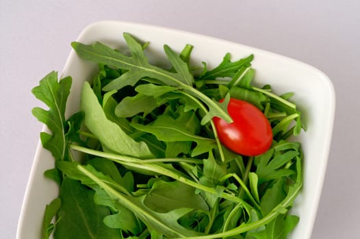 Salad with arugula and cherry tomato (closeup)