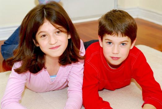 Portrait of brother and sister playing on the floor