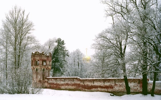 Ancient red brick walls and a cupola of church on background