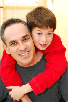 Portrait of smiling father and son inside