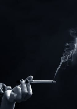 Hand with a cigarette with a smoke