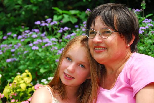 Portrait of grandmother and granddaughter in a garden