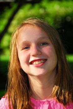 Portrait of a young girl in a summer park