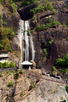 overlooking waterfalls with hanging bridge beneath

