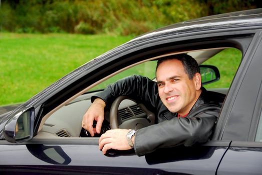 Smiling man looking from a car window