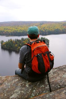 Man on top of a hill enjoying a scenic view