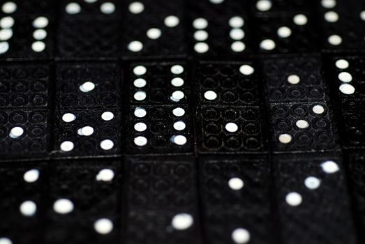 A photograph of rows of domino tiles with splodgy pips on display