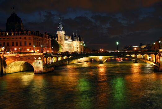 Bridges over Seine and Conciege in nighttime Paris France