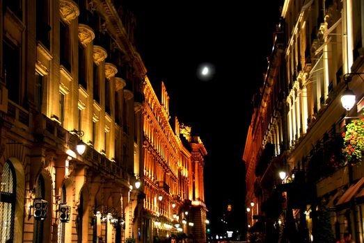 Illuminated street in Paris France with bright moon