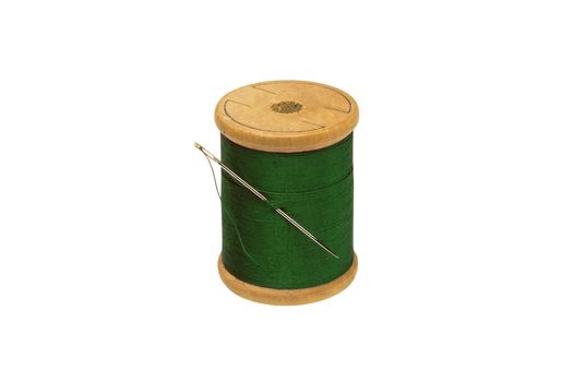 Spool of thread and needle isolated on white