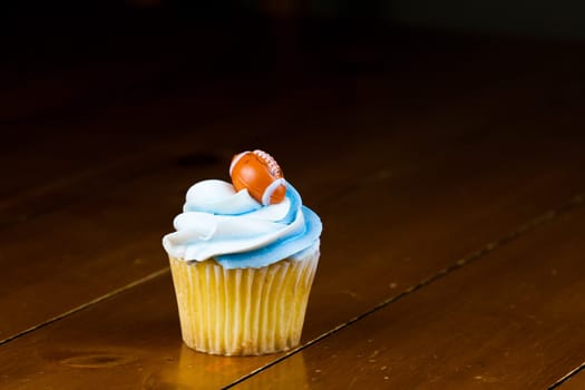 Close up of a cup cake on the wooden table