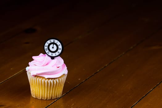 Close up of a cup cake on the wooden table