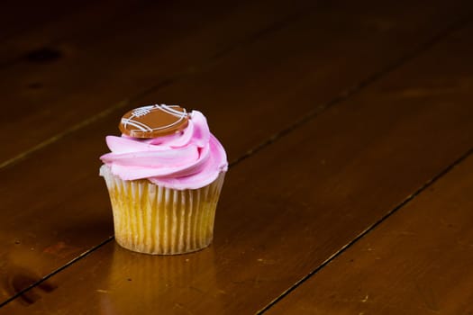 Close up of a cup cake on the wooden table