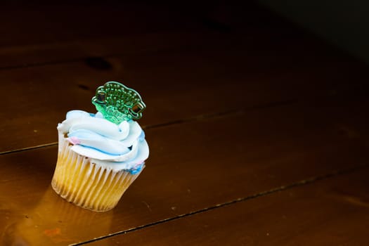 Close up of a cup cake on the wooden table