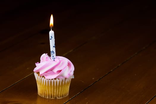 Close up of a cup cake on the wooden table