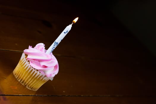 Close up of a cup cake on the wooden table