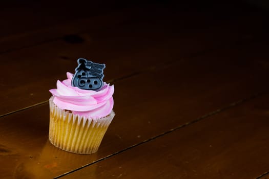 Close up of a cup cake on the wooden table