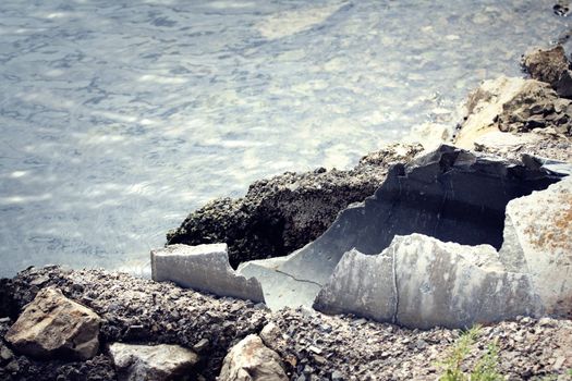 Old broken pipes with wastewater going into the sea