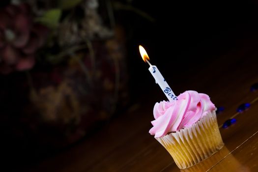 Close up of a cup cake on the wooden table