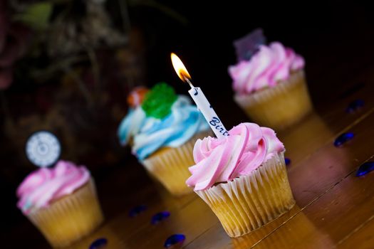 Close up of a cup cake on the wooden table