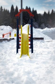 Childrens playground on a snow winter day