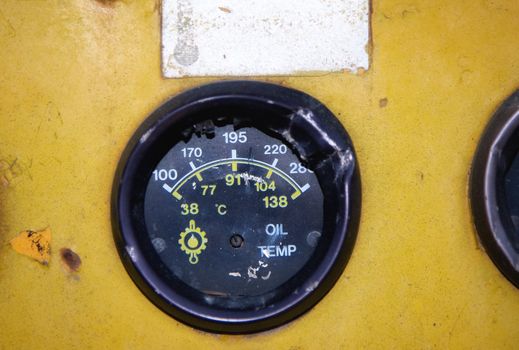 Dashboard of an old yellow abandoned industrial vehicle