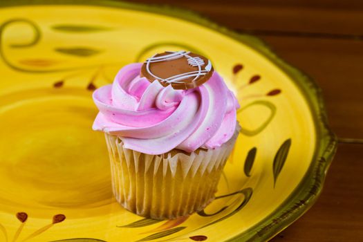 Close up of a cup cake on the wooden table