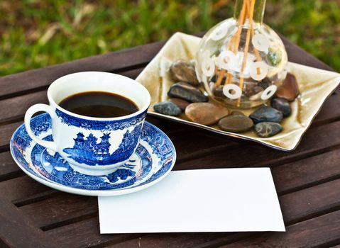 Close up of a cup of coffee on the table with a note