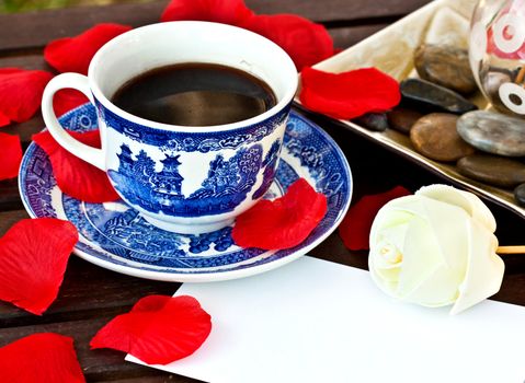 Close up of a cup of coffee on the table with a note