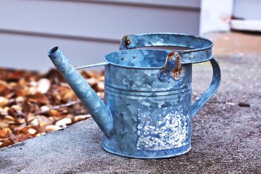 Close up of a grey bucket sitting outside on a rock