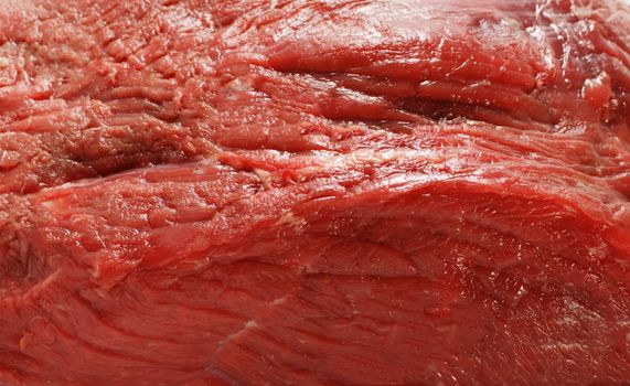 A close-up view of four rump steaks on a white background.