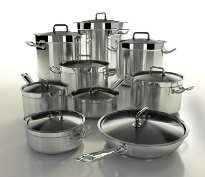 A set of stainless steel pans on a light backgroun