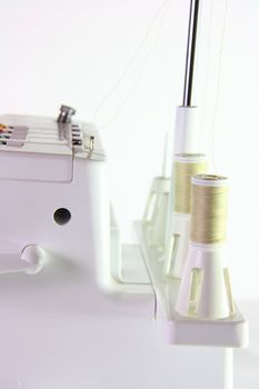 side of sewing machine on white background