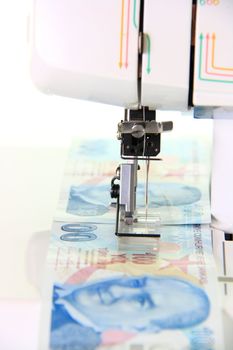 sewing machine sewing money turkish lira on white background