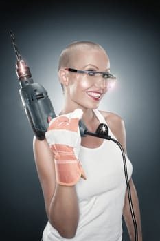 portrait of young beautiful  woman with drill on blue back