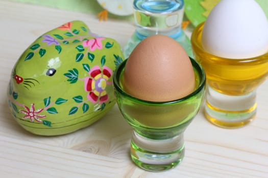 Easter wooden bunny and eggs in egg holders