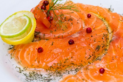 Salmon carpaccio with pink pepper and juice of lemons