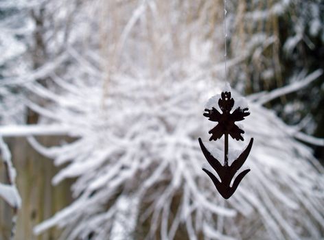 Snow Covered Tree Branches and Rusty Flower Windchime