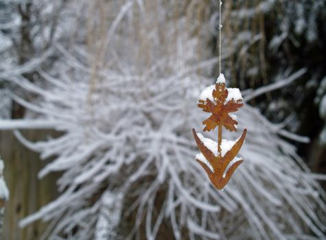 Snow Covered Tree Branches and Rusty Flower Windchime