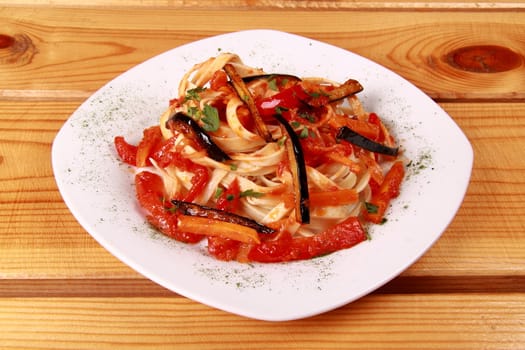 penne all'arrabbiata , italian pasta dish isolated on wooden