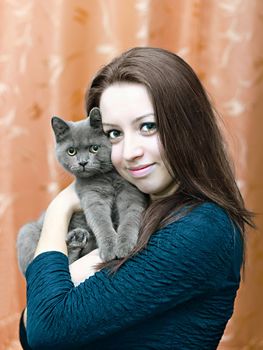 portrait of a beautiful young girl with a cat on hands