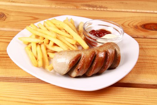 grilled sausages with French fries and ketchup