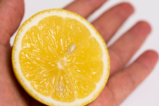 Half of a lemon in an open hand